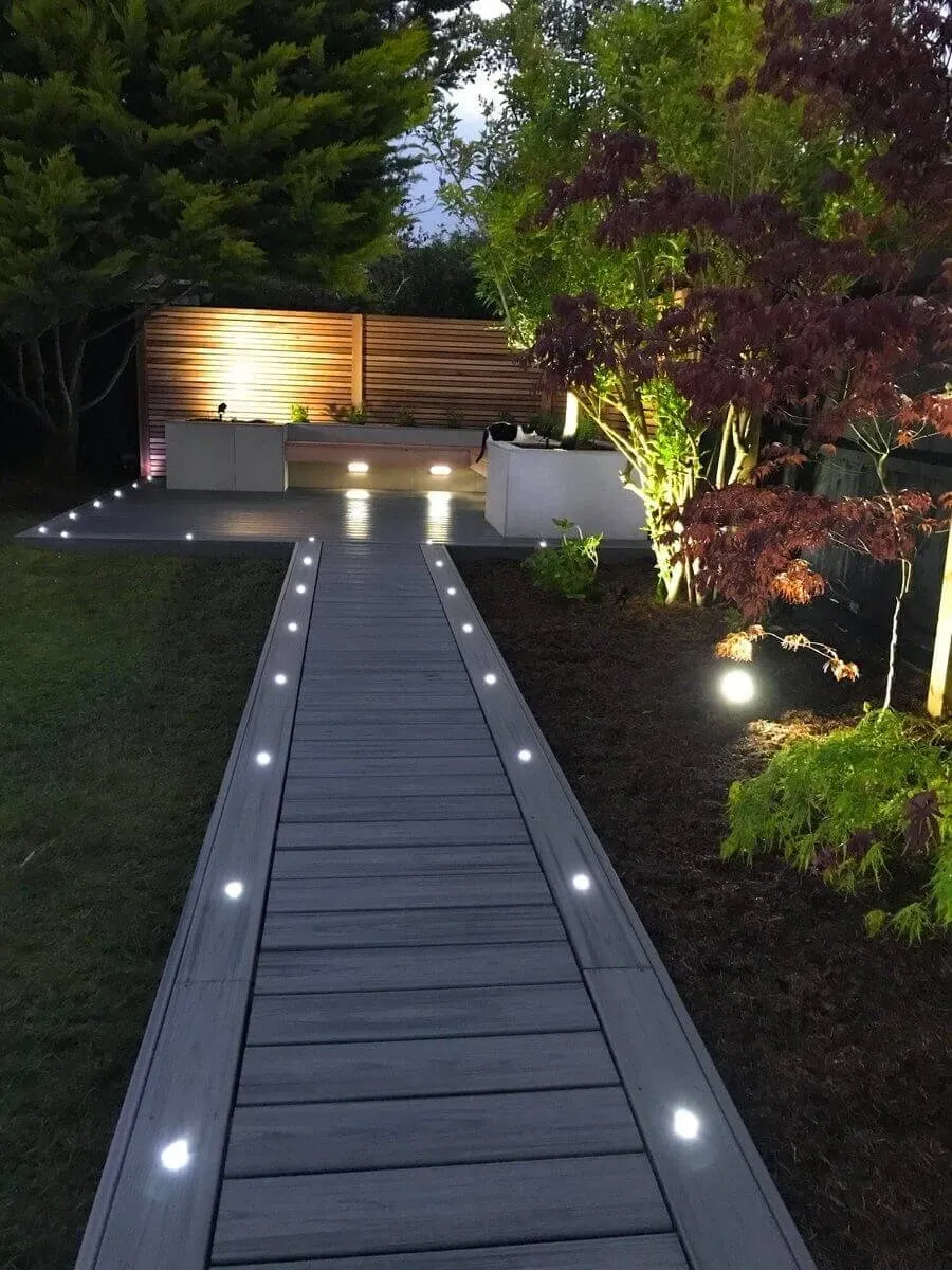 Modern garden path with illuminated decking.