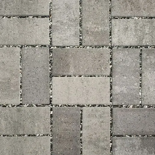 Gray brick paving in herringbone pattern.