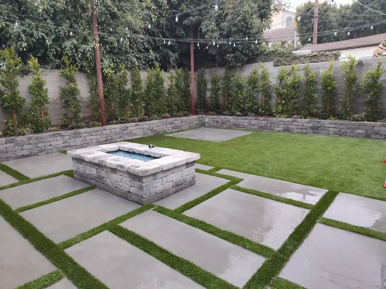 Modern backyard with stone fire pit.