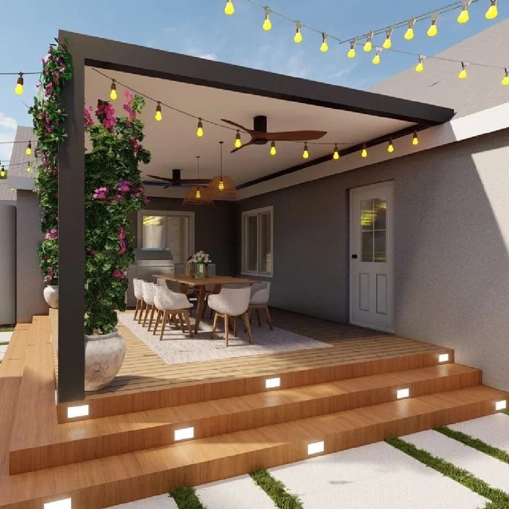 Modern outdoor patio with wooden deck, dining area, and string lights.