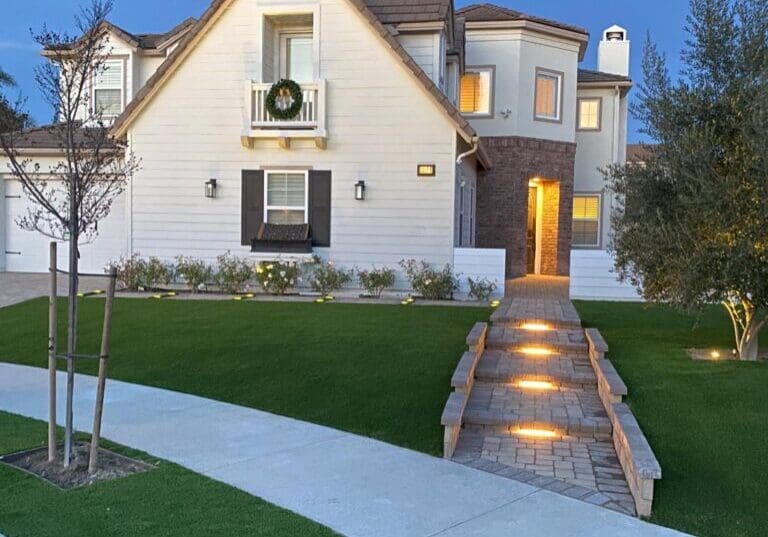 front yard of home with pavers and turf