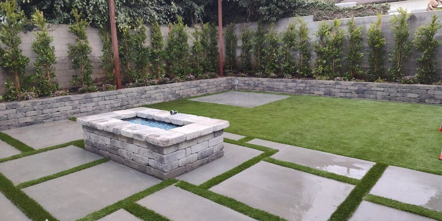 Modern backyard with fire pit and lawn.