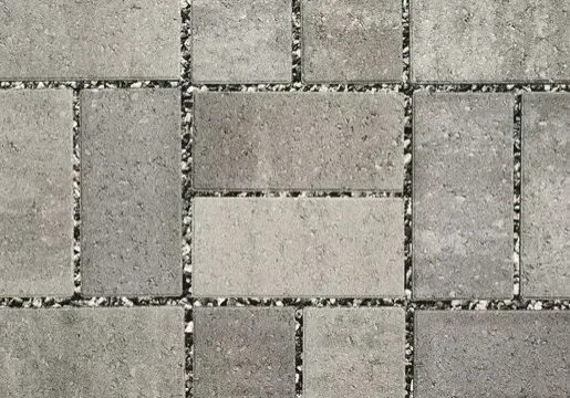 Gray brick paving in herringbone pattern.